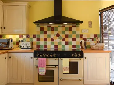a kitchen with a stove top oven in a kitchen at Lawford Lodge in Bonnybridge