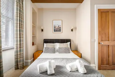 a bedroom with a bed with two white pillows at Stylish & Central 2BR Stockbridge Gem in Edinburgh