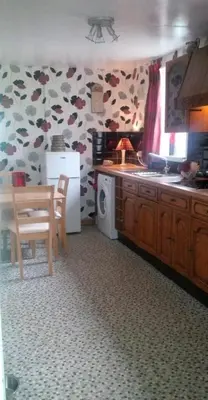 a kitchen with a sink and a table and a microwave at Argyllholidaycottage Loch Awe in Eredine