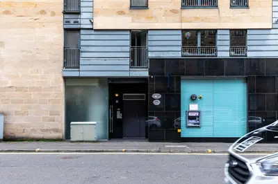 a building with a blue door on a street at Merchant City Modern 1 Bed Executive Flat in Glasgow