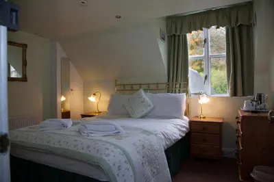 a bedroom with a bed with two towels on it at Dunchraigaig House in Kilmartin