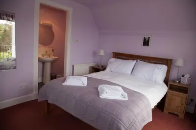 a bedroom with a bed with two towels on it at Dunchraigaig House in Kilmartin