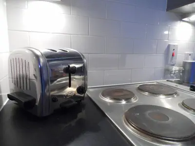 a toaster sitting on top of a stove in a kitchen at Art Deco Building on Vibrant Sauchiehall Street in Glasgow