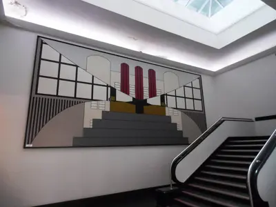a wall with a painting of a staircase with red candles at Art Deco Building on Vibrant Sauchiehall Street in Glasgow