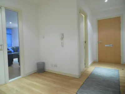 an empty living room with a door and a rug at Modern 2-bedroom Apt near SSE Hydro and SEC in Glasgow