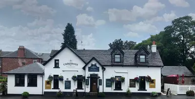a white inn with flowers in the windows at Cardross Inn in Cardross