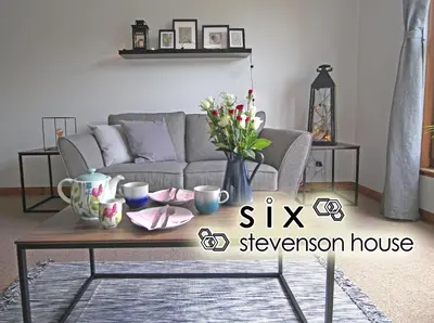 a living room with a couch and a coffee table at Six Stevenson House, Oban in Oban
