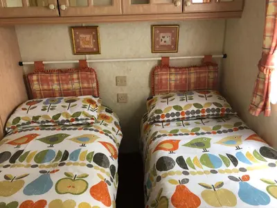 two beds in the corner of a room at Lyndhurst 39 in Dunoon