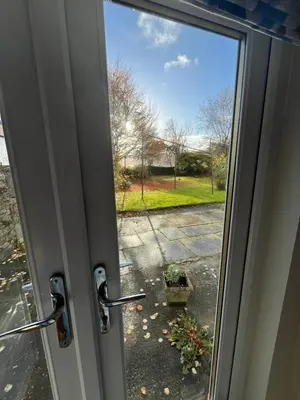 a sliding glass door with a view of a yard at Kilmory Garden by the Loch in Lochgilphead