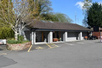 a parking lot in front of a building at Lomond Woods Holiday Park in Balloch