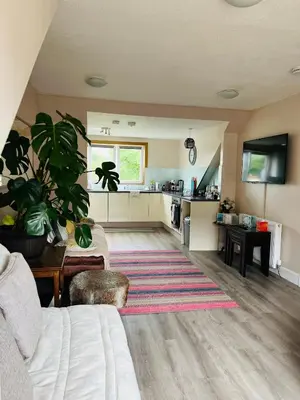 a living room with a couch and a kitchen at “A Wee Pad in Dunfermline” in Dunfermline