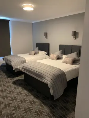 two beds in a hotel room with at The Royal Hotel in Stranraer