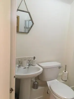 a white bathroom with a toilet and a sink at The Farmhouse B&B in Dunkeld