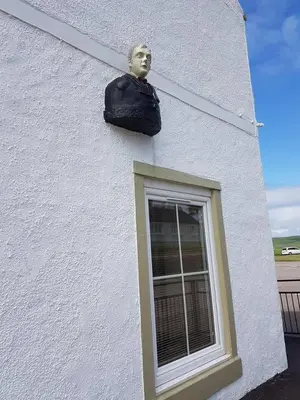 a bust of a man on the side of a building at Modern 1 bed Apartment close to Campbeltown in Campbeltown