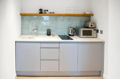 a kitchen with a sink and a microwave at The Salt Lodge in Troon