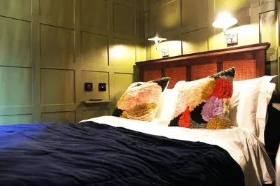 a bedroom with a bed with pillows on it at Boutique Bothy - Unique Bolthole in the New Town in Edinburgh