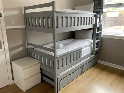 a white bunk bed in a room with a window at The Abercromby Townhouse - Close to Merchant City in Glasgow