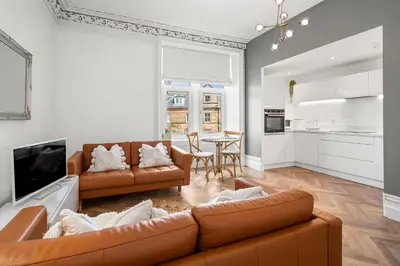a living room with two brown couches and a table at Exceptional Central 1BR Apt - town square views in Oban