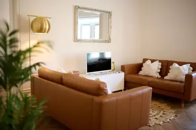 a living room with two couches and a television at Exceptional Central 1BR Apt - town square views in Oban