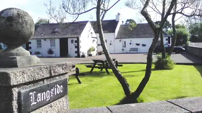 a park with a bench and a tree in the grass at Langside Bed and Breakfast in Fenwick