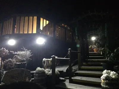 a house with lights on the side of it at night at Ramintoul Lodge in Glendevon