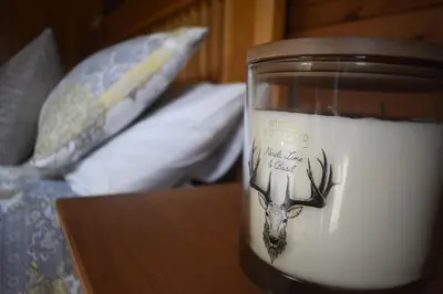 a candle with a deer head on the inside of it at Lodge at Loch Lomond in Glasgow