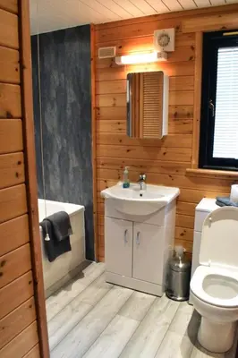 a bathroom with a white sink and a toilet at Lodge at Loch Lomond in Glasgow