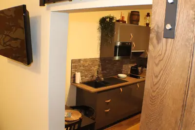 a small kitchen with a sink and a microwave at The Victoria Inn Blythswood Snug in Falkirk