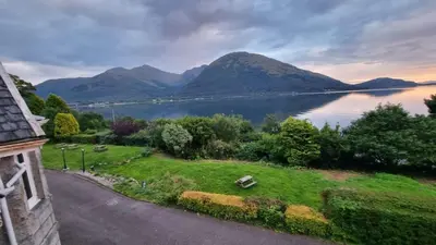 a view of a lake from a house at The Lodge on the Loch by OYO in Onich