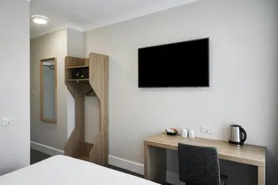 a bedroom with a desk and a tv on a wall at Four Points Flex by Sheraton Edinburgh in Edinburgh