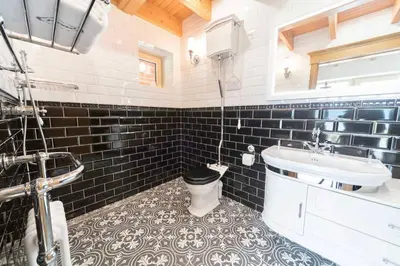 a bathroom with a sink and a toilet in it at Knockderry Lodge -Private Luxury pet-friendly accommodation in Scotland with hot tub in Cove