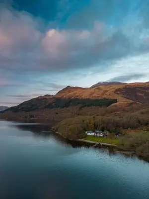 a view of a body of water with hills at Rowardennan Youth Hostel in Rowardennan