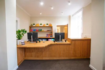 an office with a wooden desk with two monitors on it at Rowardennan Youth Hostel in Rowardennan
