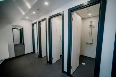 a row of elevators in a hallway with mirrors at Rowardennan Youth Hostel in Rowardennan