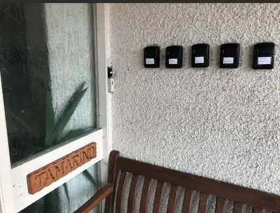 a wall with a bench next to a house with cell phones at The Clan MacGregor Room in Kilmarnock