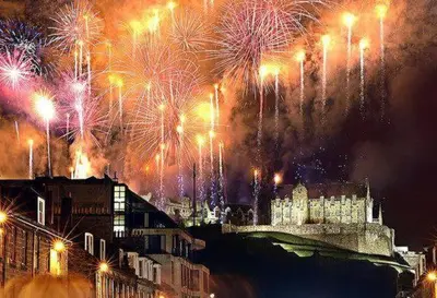 a fireworks display over a city with buildings at Hilltop House in Airdrie
