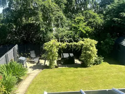 a garden with a gazebo and chairs in a yard at Meadow House- Driveway Parking and Fireplace in East Kilbride
