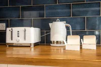a toaster and a tea kettle on a counter at GuestReady - Spacious and Beautiful 2BR Flat in Morningside in Edinburgh