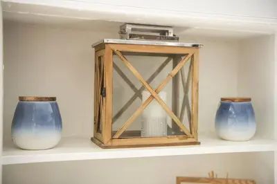 a shelf with two blue vases and a wooden box at GuestReady - Spacious and Beautiful 2BR Flat in Morningside in Edinburgh