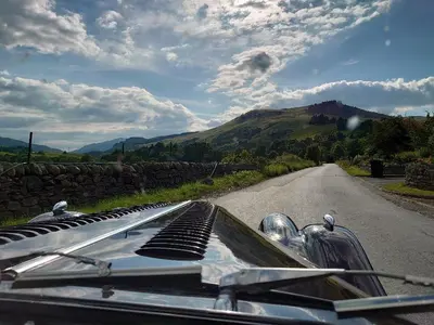 a close up of the hood of a car on a road at A Fairytale Highland Cottage in Aberfeldy