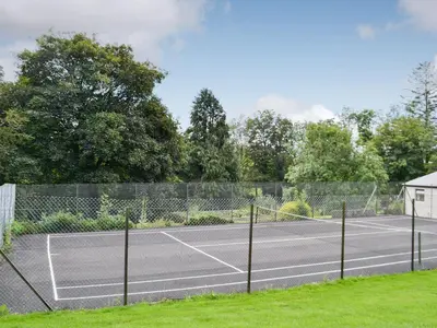 a tennis court with a net on it at The Brewers Cottage in Mauchline