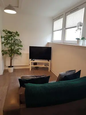 a living room with a couch and a flat screen tv at Carvetii - Edward House C - 2 Dbl bed 2nd floor flat in Dunfermline