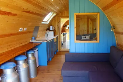 a kitchen with blue walls and a counter in a cabin at Cairnfold Cabins in Kilsyth