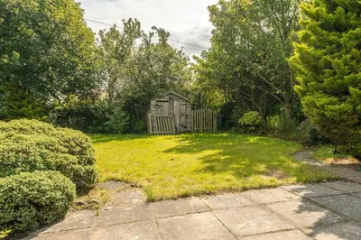 a garden with a small shed in the middle of a yard at Arran View in Prestwick