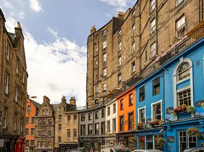 a row of buildings on a street in a city at 2BR Grassmarket Apartment with Castle View in Edinburgh
