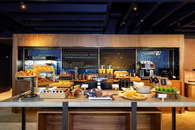 a large kitchen with a table with food on it at Wilde Aparthotels Edinburgh Grassmarket in Edinburgh