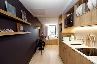 a small kitchen with a counter and a table at Wilde Aparthotels Edinburgh Grassmarket in Edinburgh