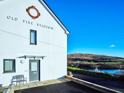 a white building with a sign that reads old fire station at Blue Watch in Lochaline