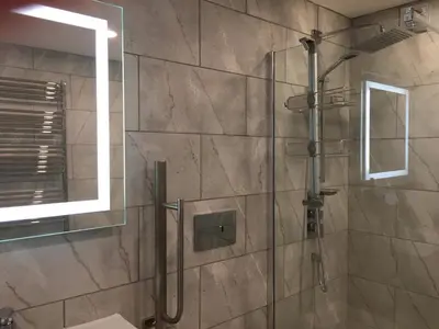 a bathroom with a shower with a glass door at Blue Watch in Lochaline