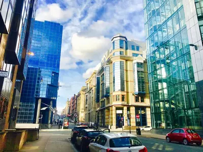 a city street with cars parked next to tall buildings at Glasgow City Centre - The PENTHOUSE with RiverViews - (Duplex, 3 Bedrooms, 3 Bathrooms, 2 Living rooms/Kitchen, Private SKY Terrace, 2 Parkings, Top Floor, Huge - 2100 sq ft, SECC HYDRO) in Glasgow